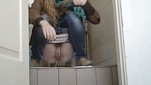 Young blondie pulls down her jeans and piddles in the toilet