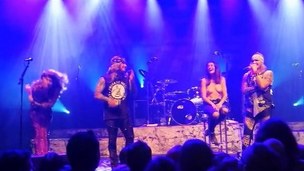 Topless girl on stage at a concert